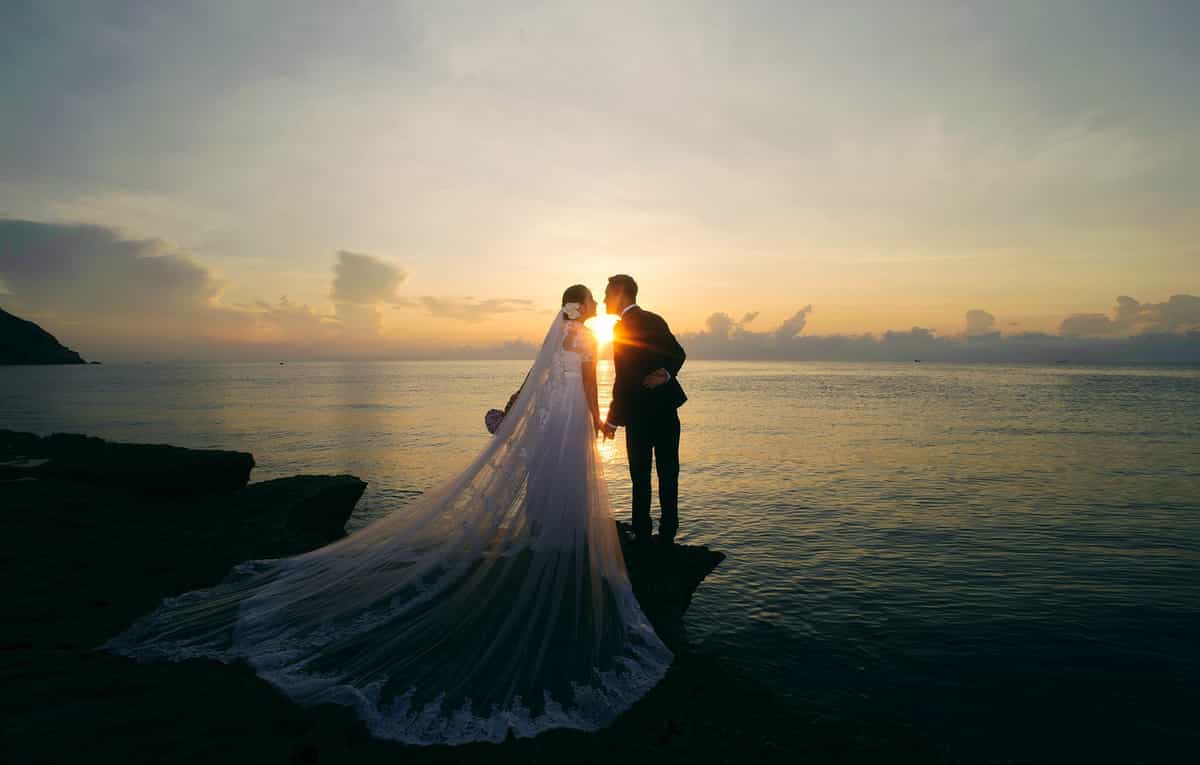 Hình ảnh chú rể hôn cô dâu dưới hoàng hôn